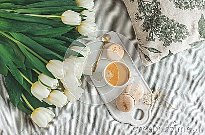 Breakfast in bed, cup of cappuccino, flowers Stock Photo