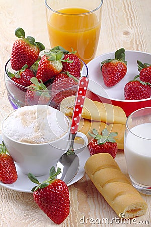 Breakfast with cappuccino, afternoon snack, strawberries and fruit juice Stock Photo