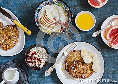 Breakfast - caramel french toast with banana, cottage cheese with granola and pomegranate, oatmeal porridge, fresh grapefruit on Stock Photo