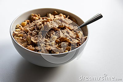 Breakfast cereals with healthy cornflakes and delicious walnuts and honey in a bowl are the perfect start in the day Stock Photo