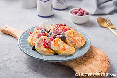 Breakfast with cheesecake, fresh berries . Cottage cheese pancakes or curd fritters. Russian syrniki or sirniki Stock Photo