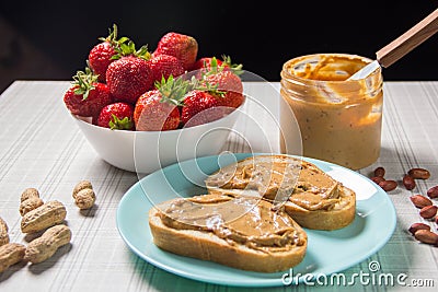 Breakfast with coffee and sandwiches with peanut paste and strawberries Stock Photo