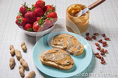 Breakfast with coffee and sandwiches with peanut paste and strawberries Stock Photo