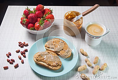 Breakfast with coffee and sandwiches with peanut paste and strawberries Stock Photo