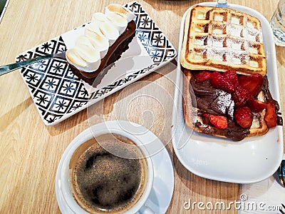 Breakfast of coffee, waffle with nutella and strawberries Stock Photo