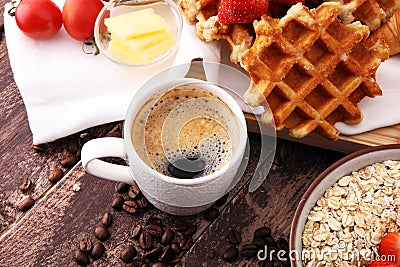 Breakfast with coffee and waffle, strawberries on brown wooden b Stock Photo