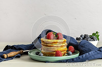 Breakfast concept with american pancakes with raspberries, mint, and blueberries Stock Photo