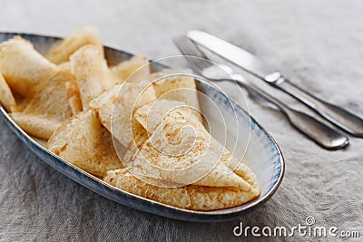 Breakfast with crepes or pancakes on greige linen tablecloth Stock Photo