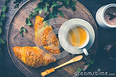 Breakfast - Croissants with nuts and cup of coffee on morning table Stock Photo