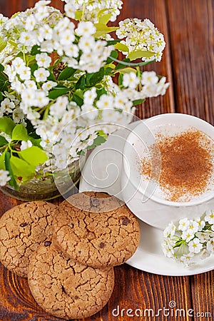 Breakfast with a cup of cappuccino with cinnamon and chocolate chip cookies Stock Photo