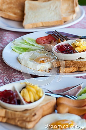 Breakfast with fried eggs, sausages, cereal, toasts and coffee Stock Photo