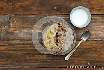 Breakfast with Granola Bowl, Muesli with Oats, Nuts and Dried Fruit, Milk, on Wooden table. Bannana, nuts, fruits. Healthy Breakfa Stock Photo