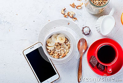 Breakfast granola, a cup of coffee and phone Stock Photo