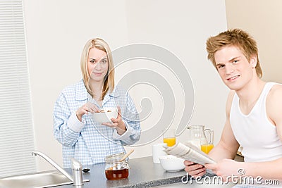 Breakfast happy couple eat cereal read newspaper Stock Photo