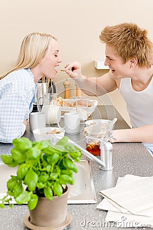 Breakfast happy couple man feed woman cereal Stock Photo