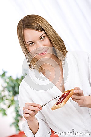 Breakfast - Happy woman with toast and marmalade Stock Photo