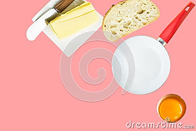 Breakfast ingredients butter slice of bread cracked raw egg frying pan on pink background. Culinary food poster Stock Photo