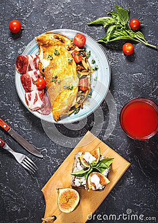 Breakfast mushrooms omelet and sandwich with figs on stone background. Top view. Stock Photo