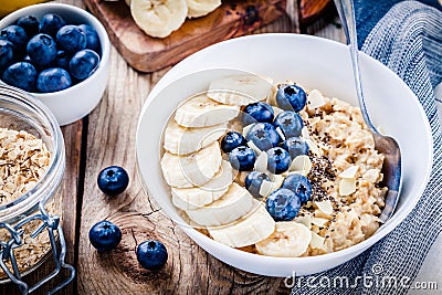 Breakfast: oatmeal with bananas, blueberries, chia seeds and almonds Stock Photo