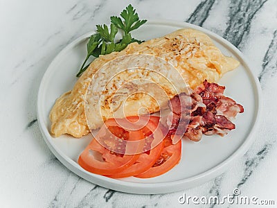 Breakfast omelet of eggs on a white marble background. Stock Photo