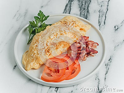 Breakfast omelet of eggs on a white marble background. Stock Photo