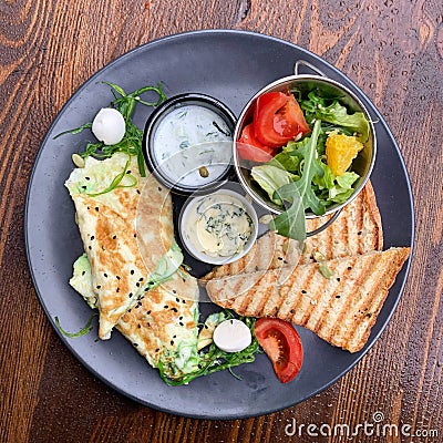 Breakfast. Omelet with mozzarella cheese and chukka salad. Stock Photo