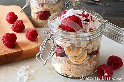 Breakfast overnight oats with fresh raspberries in a jar Stock Photo