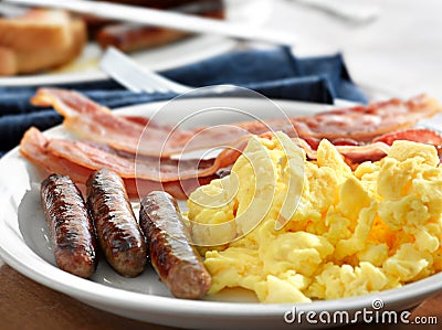 Breakfast - scrambled eggs, sausage, and bacon Stock Photo