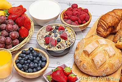 Breakfast Served in the morning with Butter croissant and corn flakes Whole grains and raisins with milk in cups and Strawberry, Stock Photo