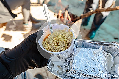 Breakfast for tourist in foiled pack with cooked instant noodle in the bowl in winter in Zero Point at Lachung. North Sikkim Stock Photo