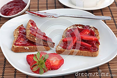 Breakfast of wholemeal toast with strawberry jelly Stock Photo