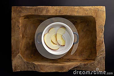 Breakfast on a wooden rectangular bowl with a black and white pot. Stock Photo