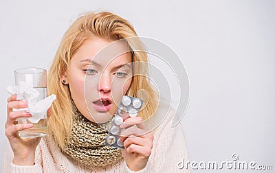 Breaking fever concept. Headache and fever remedies. Woman sick person hold glass water and tablets blister. Take pills Stock Photo