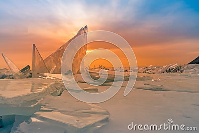 Breaking ice on freezing water lake with after sunset sky, Baikal Russia Stock Photo
