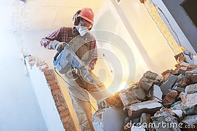 Breaking interior wall. worker with demolition hammer Stock Photo