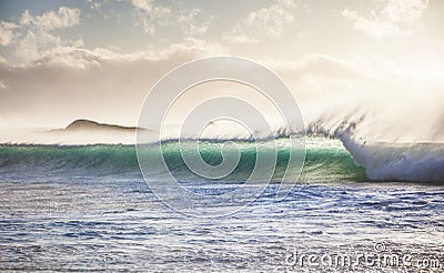 Breaking ocean wave at sunset Stock Photo