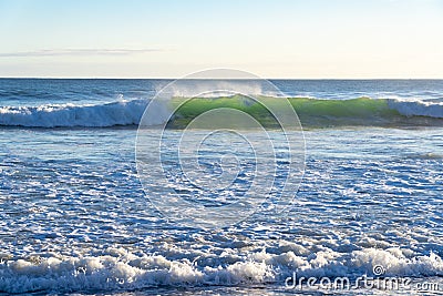 Breaking waves and and beach foam Stock Photo