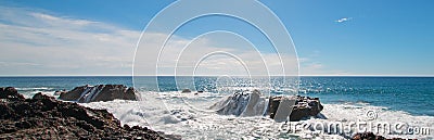 Breaking waves on rocky coastline at Cerritos Beach between Todos Santos and Cabo San Lucas in Baja California Mexico Stock Photo