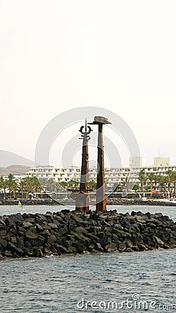 Breakwater with sculpture of Toys by Erjo in Lanzarote Stock Photo