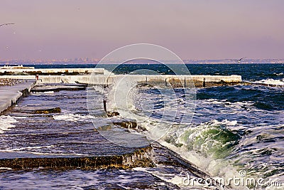 Breakwaters in the ice on frozen pier Stock Photo