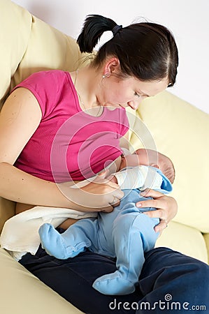Breast feeding on sofa Stock Photo