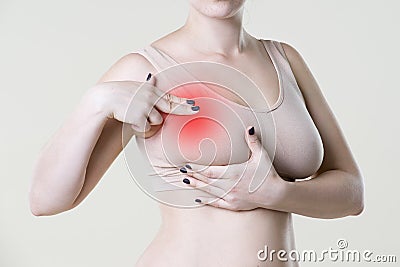 Breast test, woman examining her breasts for cancer, heart attack, pain in human body Stock Photo