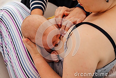 Breastfeeding consultant supports young mother to overcome problems Stock Photo