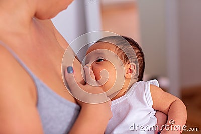 Breastfeeding - Young mother breastfeeding the newborn baby Stock Photo