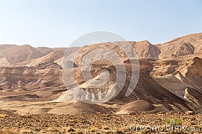 Rocky and dusty mountains in the Judaean Desert Midbar Yehuda Nature Reserve. Small Crater to Highway #90 and Golani Trail. Stock Photo