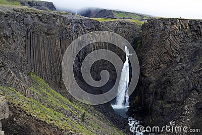 Breathtaking Litlanesfoss waterfall at east of Iceland. Waterfall is framed by basalt columns Stock Photo