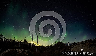 the aurora bored sky is bright green and filled with stars Stock Photo