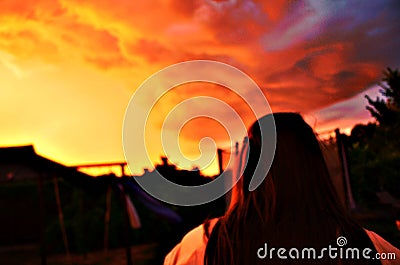 Breathtaking sunset shot with woman Stock Photo