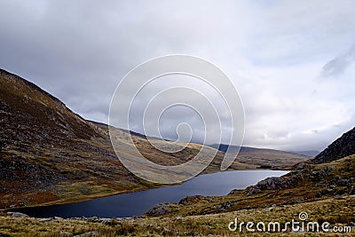 Breathtaking view of a lake surrounded by hills in National Trust, Carneddau and Glyderau Pont, UK Stock Photo