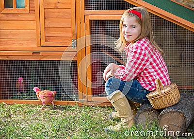 Breeder hens kid girl rancher farmer with chicks in chicken coop Stock Photo